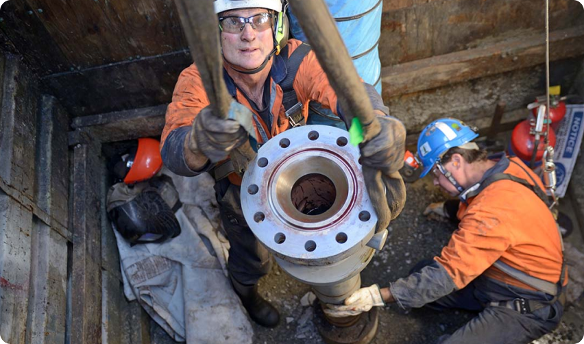 a photo a two men capping an oil well